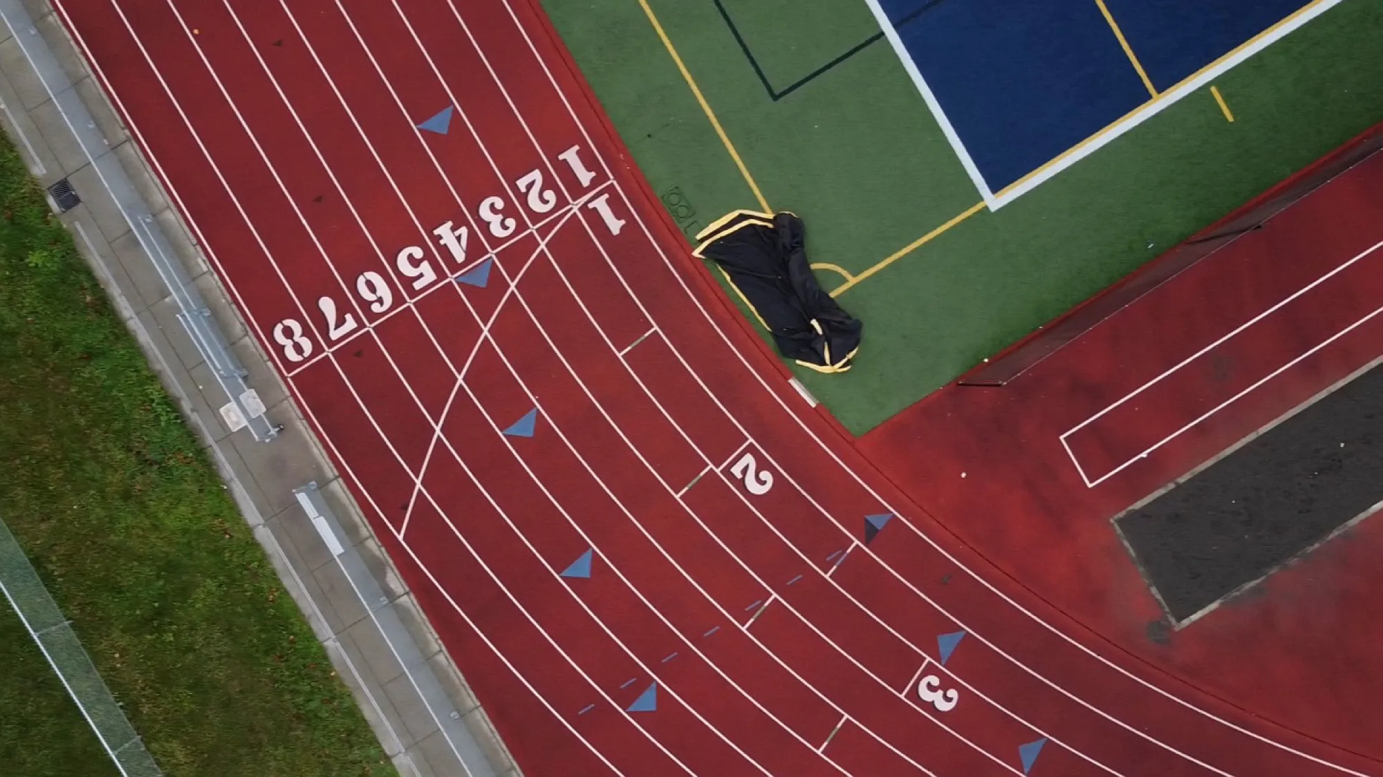 Aerial view of a running track next to a multi-sport court